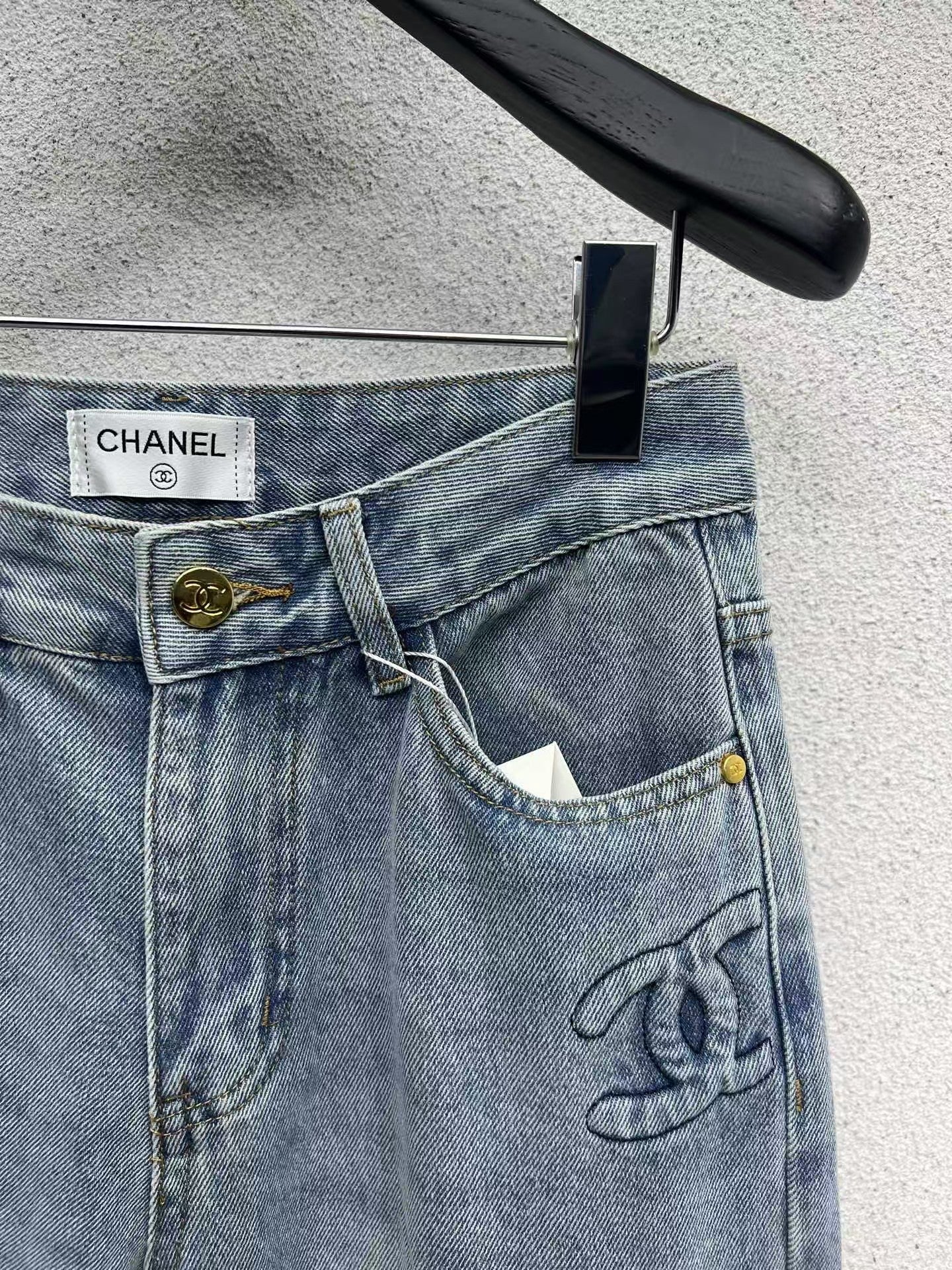 Denim trousers with embossed logo on pocket