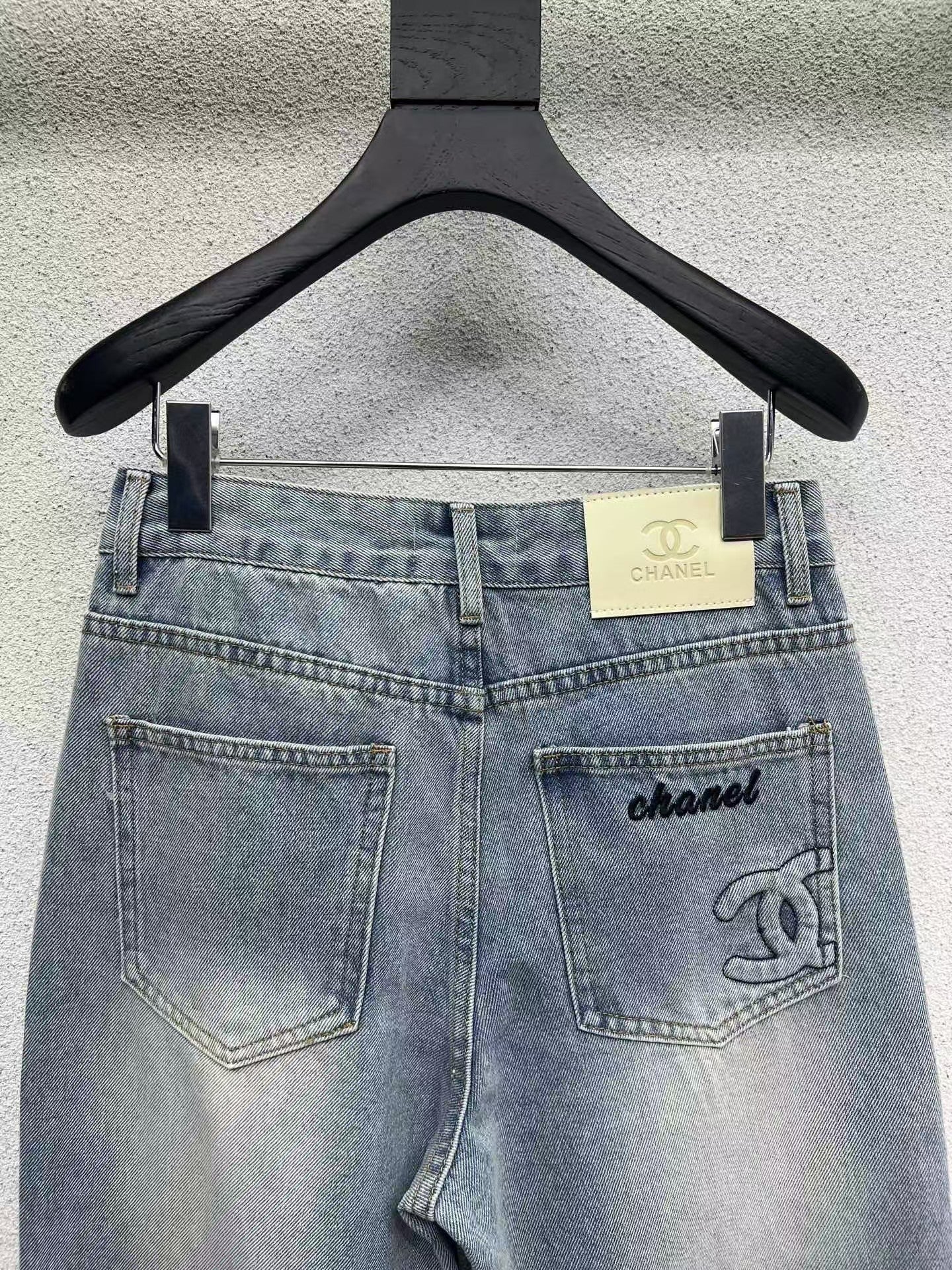 Denim trousers with embossed logo on pocket